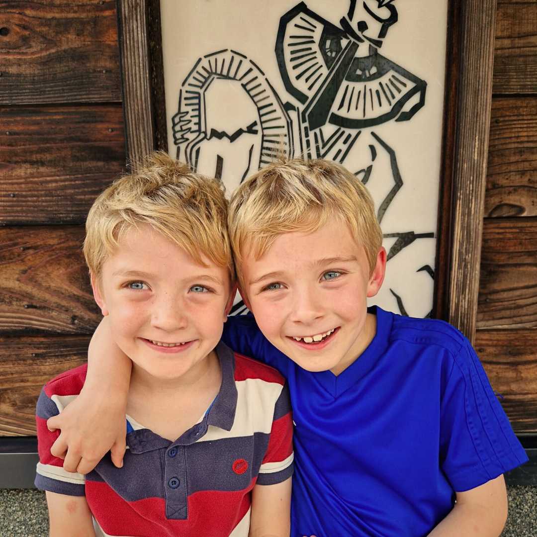 LiNGER Travel - Award-winning Creators Of Sabbaticals - Japan - Gokayama - boys sitting beneath image of local instrument
